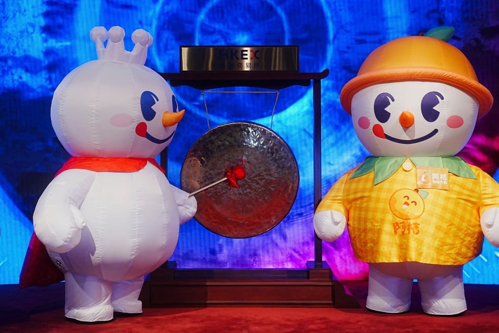 Mixue Group’s mascot strikes a gong during the company’s listing ceremony at the Hong Kong stock exchange on March 3, 2025. Photo: Reuters