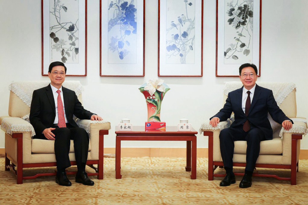 City leader John Lee (left) pays a visit to Zhou Ji, the new director of Beijing’s liaison office in Hong Kong. Photo: Handout
