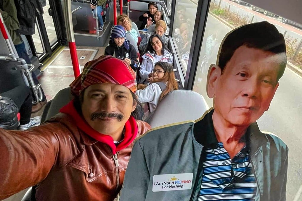 Philippine Senator Robin Padilla carries a life-size full-colour cardboard cutout of Rodrigo Duterte on a bus in The Hague. Photo: Handout