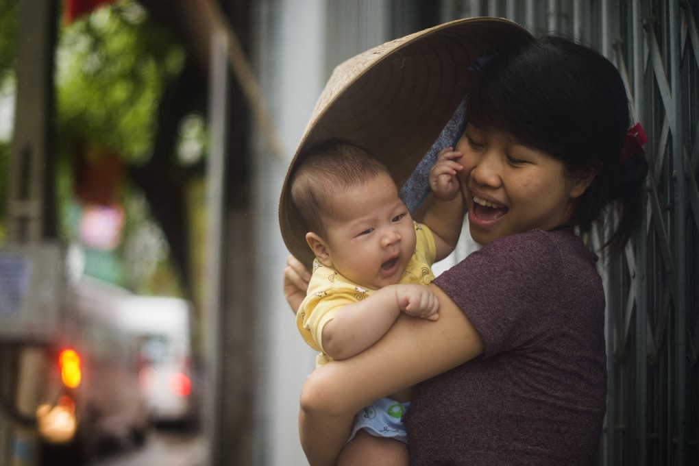 A Vietnamese woman holds her baby in Hanoi. Vietnam’s total fertility rate dropped to just 1.91 children per woman last year. Photo: AFP