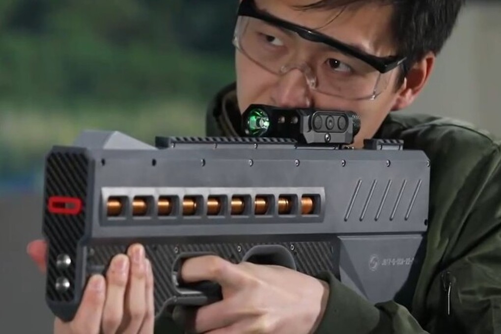 China has unveiled a powerful new electromagnetic gun believed to be powered by lithium batteries. This version (pictured) is a non-lethal weapon that fires coin-shaped bullets with electromagnetic force and would be used for riot control. Photo: CCTV