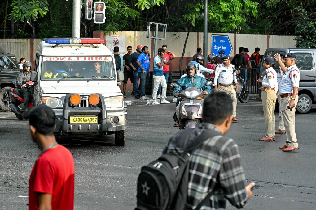 Traffic police personnel make way for an ambulance near the M. Chinnaswamy Stadium in Bengaluru on Wednesday, after casualties were reported in a stampede. Photo: AFP