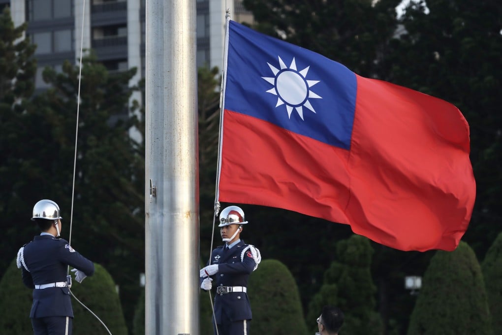 Soldiers lower the Taiwanese flag at the Chiang Kai-shek Memorial Hall in Taipei. Photo: AP