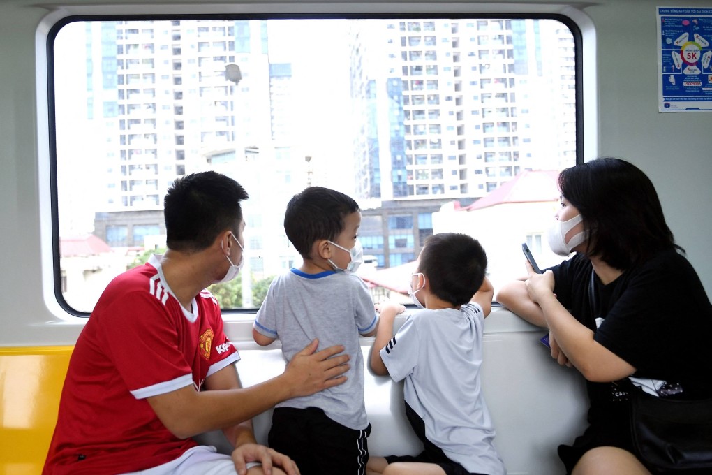 A family rides Hanoi’s first urban metro line. As Vietnam modernises, traditional preferences for sons continue to influence reproductive choices. Photo: AFP