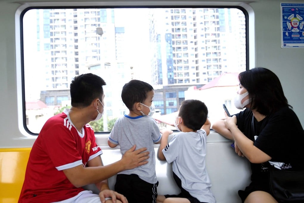 A family rides Hanoi’s first urban metro line. As Vietnam modernises, traditional preferences for sons continue to influence reproductive choices. Photo: AFP