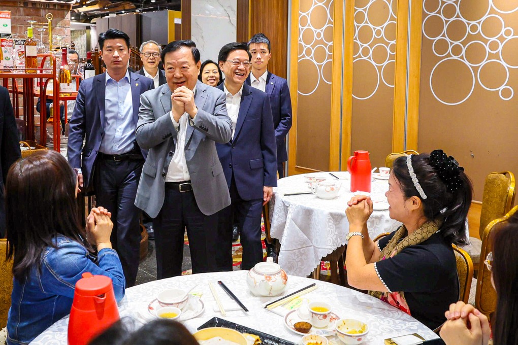 Xia Baolong (centre), accompanied by Chief Executive John Lee, meets district representatives at a restaurant in Tseung Kwan O during his last visit. Photo: HKMAO
