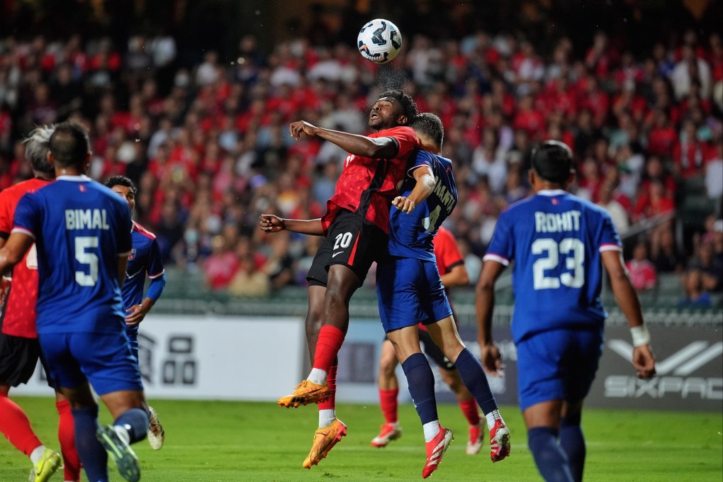 Michael Udebuluzor leaps to win a header during Hong Kong’s stalemate with Nepal. Photo: Elson Li