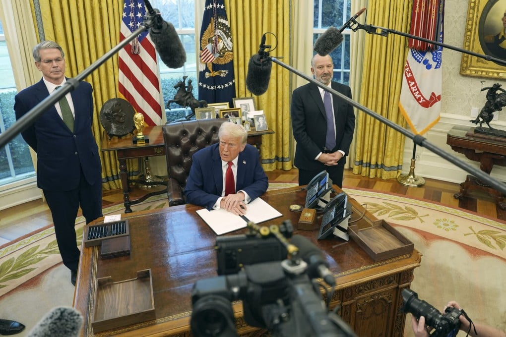US President Donald Trump speaks as Treasury Secretary Scott Bessent (left) and then Commerce secretary nominee Howard Lutnick listen as Trump prepares to sign an executive order in the Oval Office of the White House in Washington on February 3. Photo: AP