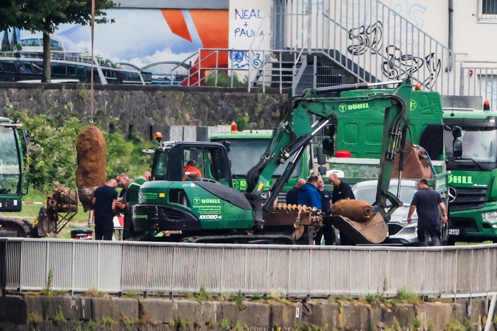 Two of the three unexploded World War II bombs are defused and prepared to be loaded onto vehicles. Photo: dpa via AP