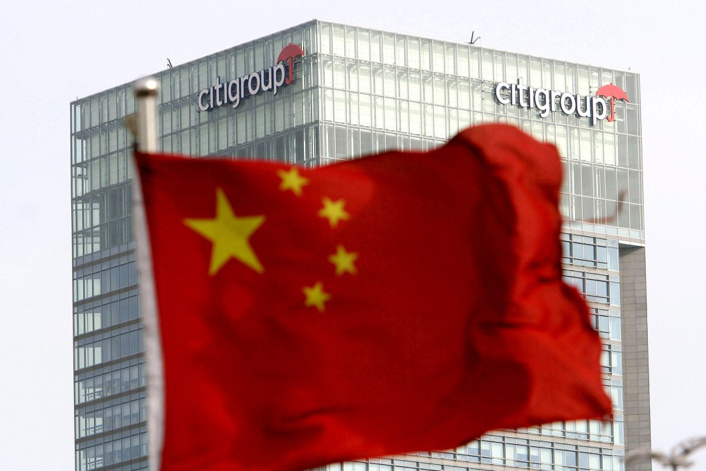 A Chinese national flag is hoisted near the Citigroup Tower in Shanghai. Photo: AP