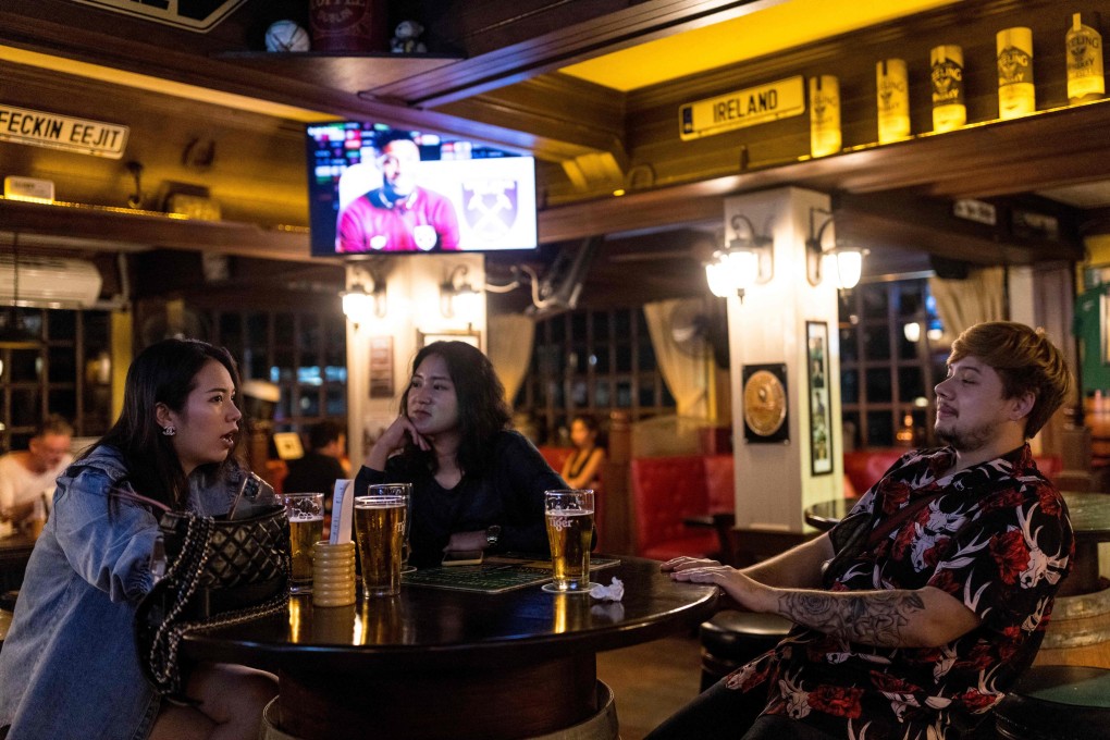 People enjoy drinks in a bar in Bangkok. A Thai teachers’ network has protested against a state agency’s partnership with a beer company to offer beer discounts for teachers. Photo: AFP