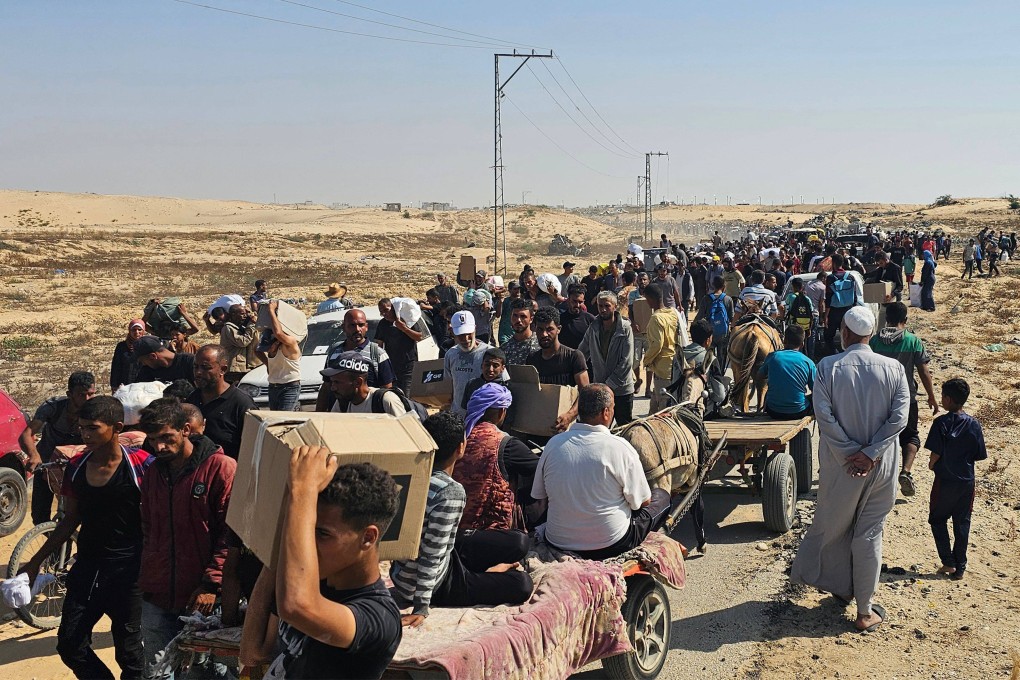 Displaced Palestinians walk along a road to receive humanitarian aid packages from a US-backed foundation in Rafah in the southern Gaza Strip on Thursday. Photo: AFP