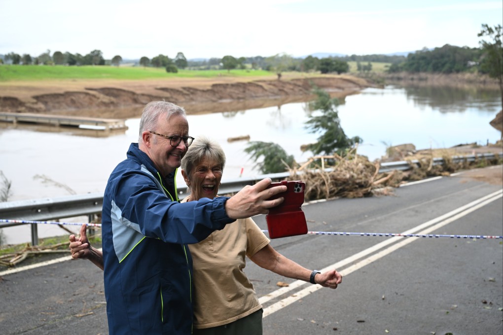Australian Prime Minister Anthony Albanese (left) takes a selfie with a resident during a visit to the flood-affected region of Taree, New South Wales, on May 27. Photo: EPA-EFE