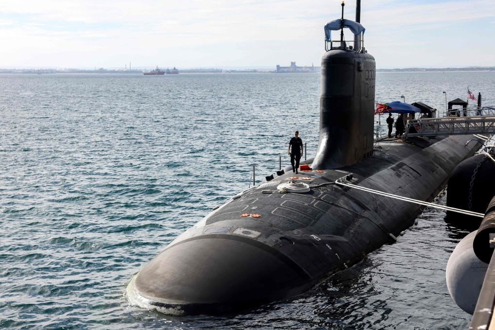US Navy officers stand guard aboard an American submarine docked in Western Australia on February 26. Photo: AFP