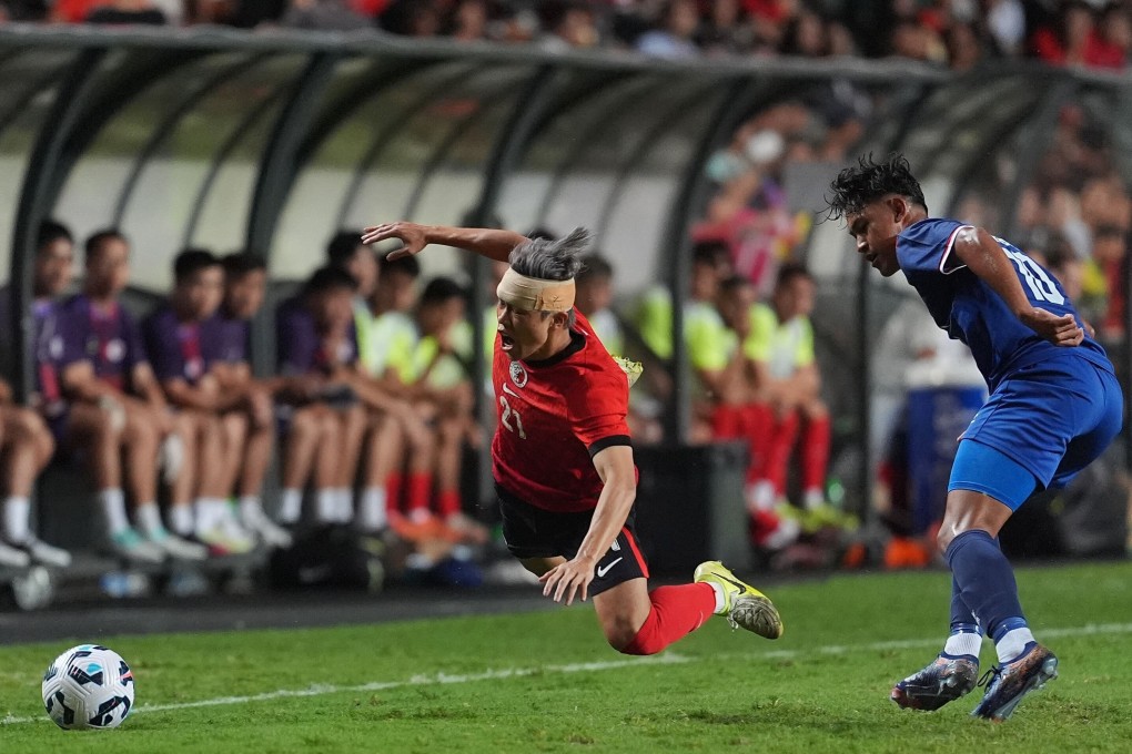 A bandaged Yue Tze-nam is sent flying during Hong Kong’s draw with Nepal. Photo: Elson Li