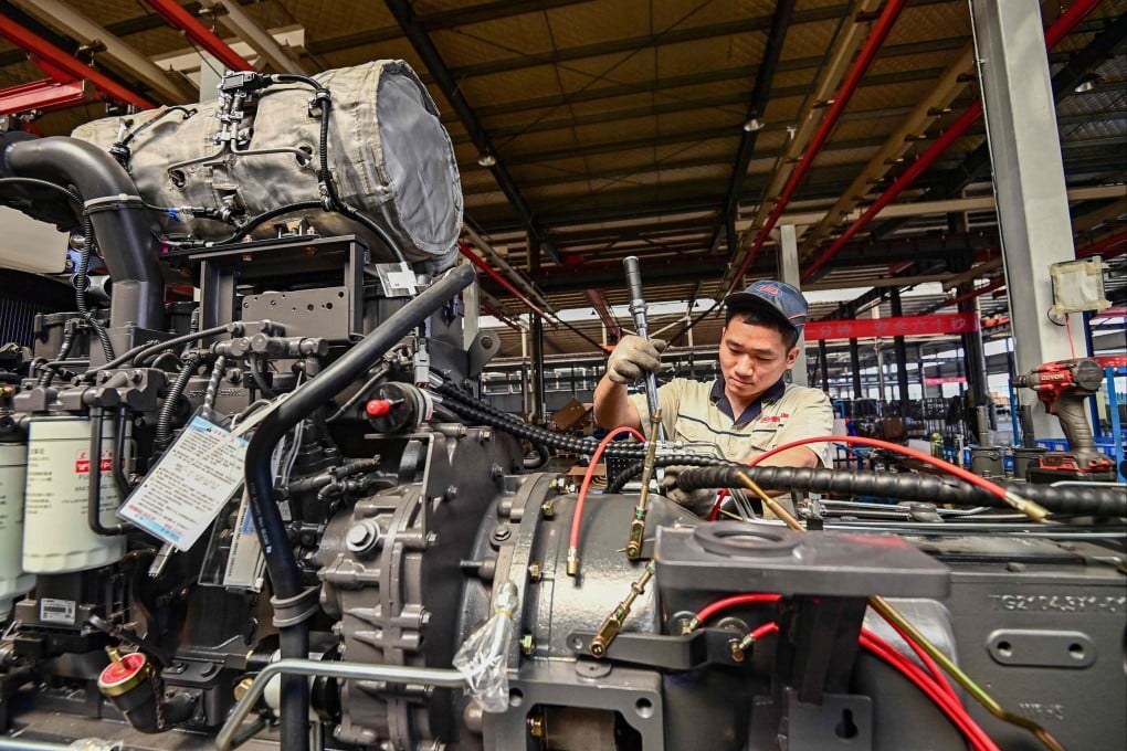 An employee works on a tractor assembly line at a factory in Qingzhou, Shandong province on May 27. Photo: AFP