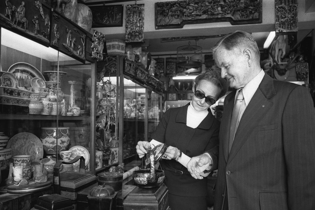 American tourists Mr and Mrs Murray Poston browse the goods on offer at an antique store in Upper Lascar Row in 1976. Photo: SCMP Archives
