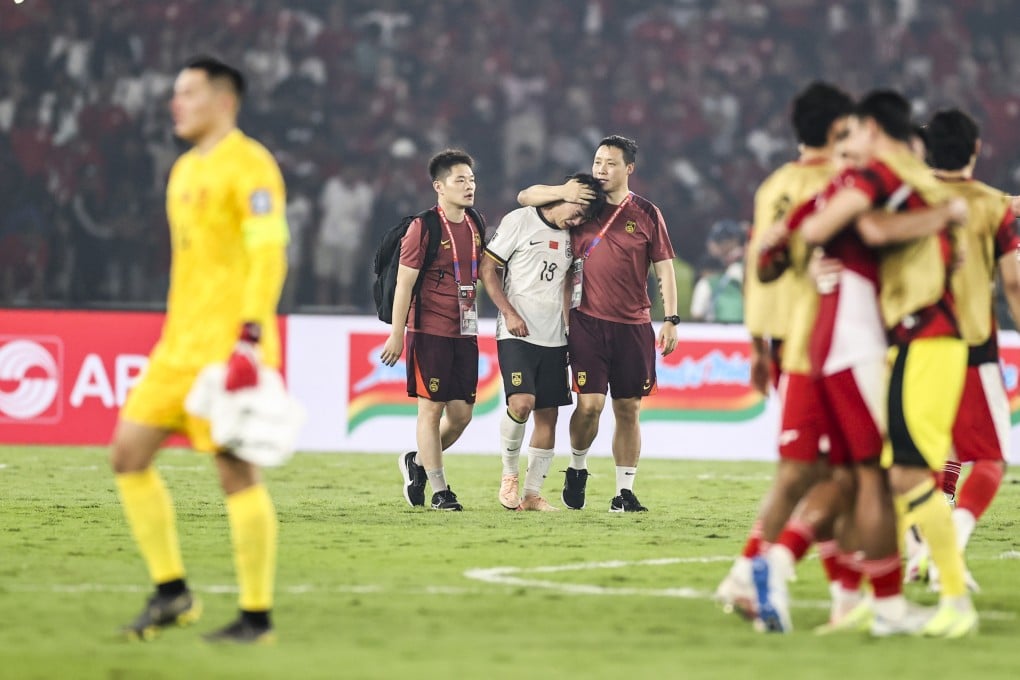 China full-back Hu Hetao (centre, rear) is consoled after defeat to Indonesia ended their hopes of reaching the 2026 World Cup finals. Photo: Xinhua