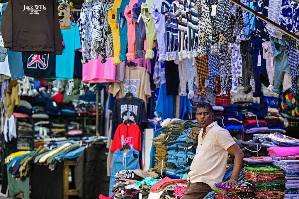 A vendor selling clothes waits for customers in Colombo. Sri Lanka’s 2022 economic crisis has exposed structural weaknesses such as its import dependency and limited capacity for value-added exports, analysts say. Photo: AFP