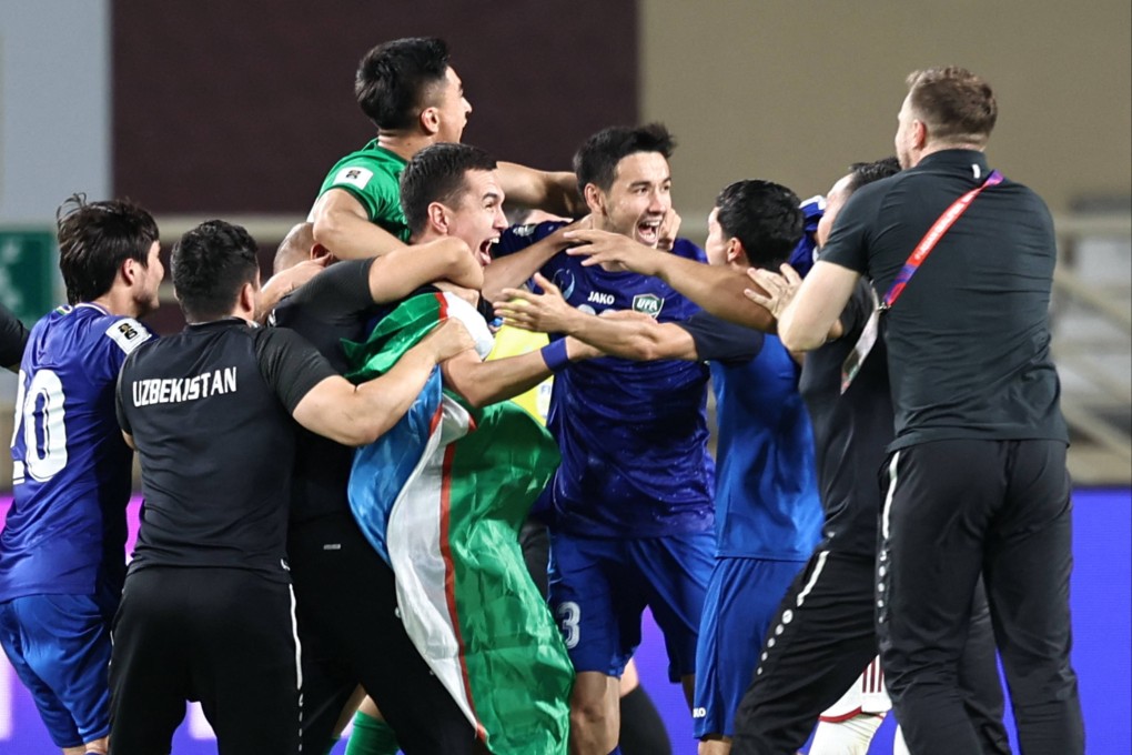 Uzbekistan’s players celebrate after their match against the United Arab Emirates ended in a draw, qualifying them for their first World Cup finals. Photo: AFP