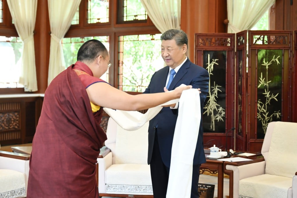 The 11th Panchen Lama presents a traditional Tibetan ceremonial scarf to President Xi Jinping as they meet in Beijing on Friday. Photo: Xinhua
