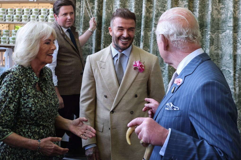 Britain’s King Charles III and Queen Camilla with businessman and retired footballer David Beckham at the RHS Chelsea Flower show in London in May. Photo: AFP