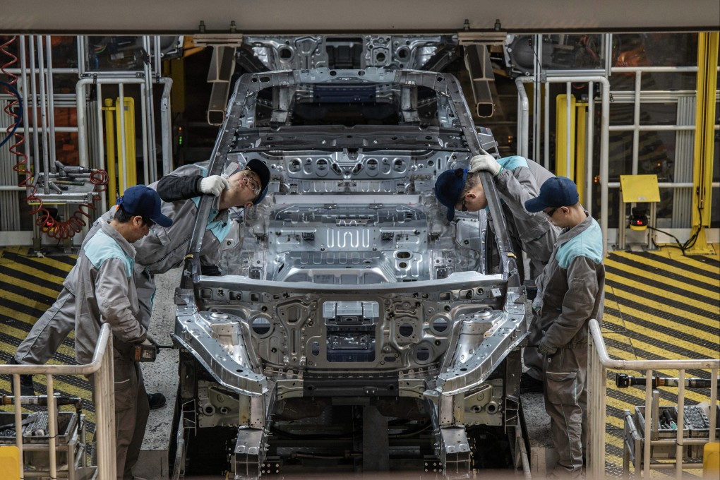 Nio workers inspect a vehicle chassis on an automated production line in Hefei, China, on January 17. Photo: Getty Images