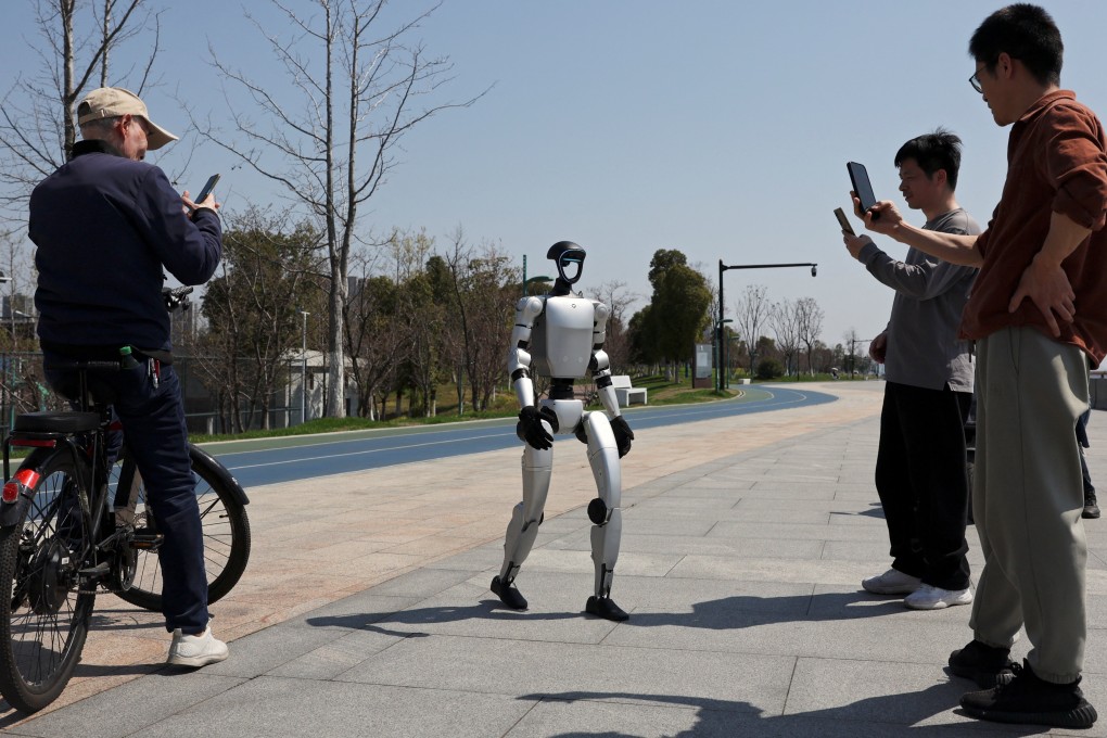 Passersby film a Unitree G1 humanoid robot at a park in Hangzhou, capital of eastern Zhejiang province. Photo: Reuters