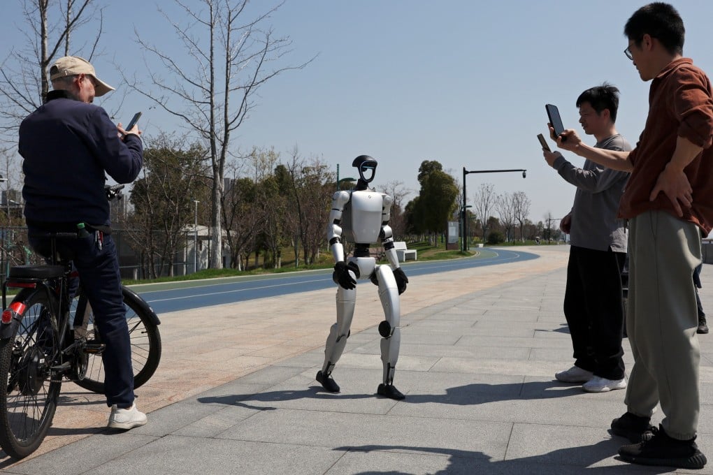 Passersby film a Unitree G1 humanoid robot at a park in Hangzhou, capital of eastern Zhejiang province. Photo: Reuters