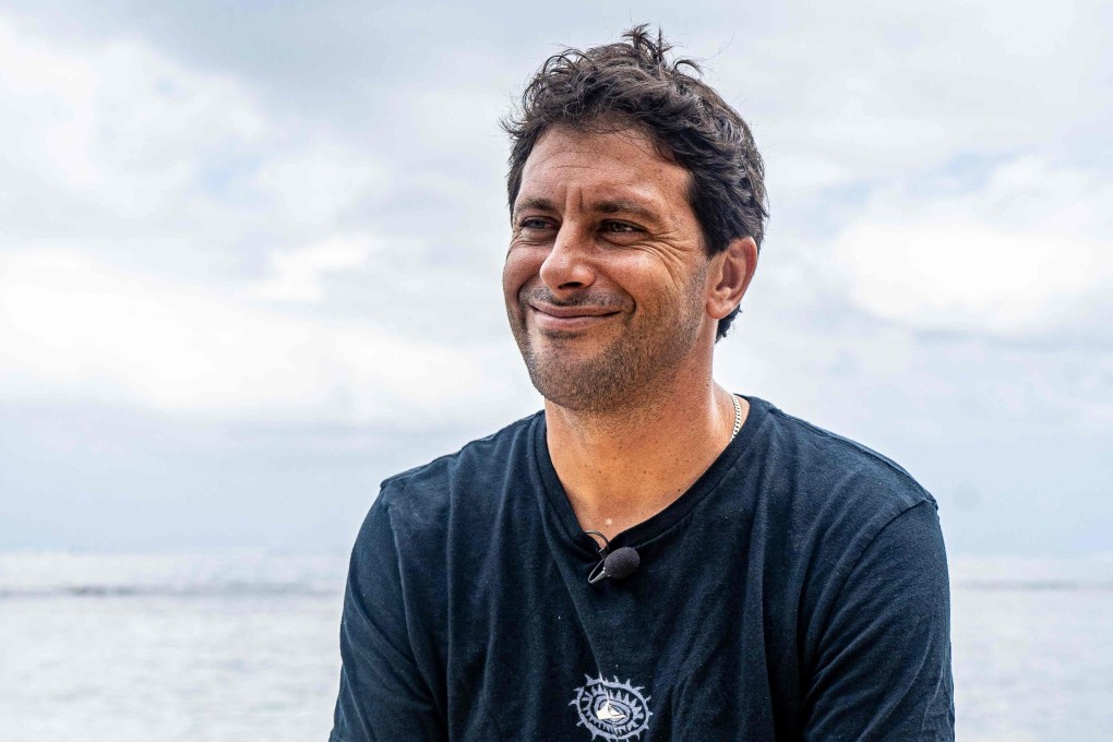 Former French surfer Jeremy Flores, who turned consultant-coach of France’s surf Olympic team, speaks in Teahupo’o, Tahiti, at the Tahiti Pro competition on May 20, 2024. Photo: AFP