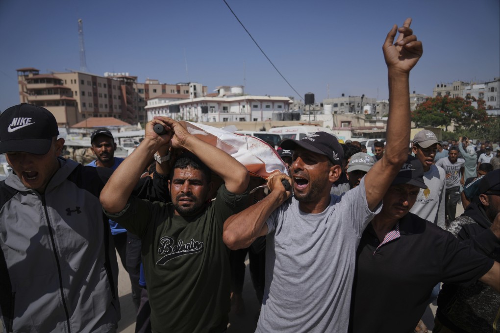 Palestinians carry the body of Ahmed Abu Hilal, who was killed while on his way to an aid hub in Gaza, during his funeral in Khan Younis, southern Gaza on Sunday. Photo: AP