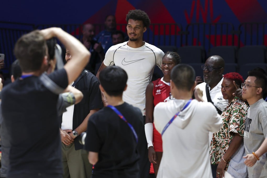 French basketball player Victor Wembanyama poses with France’s Iman Ndiaye after the Pool 3 match between France and Belgium at the Women’s Volleyball Nations League in Beijing on June 6. Photo: Xinhua