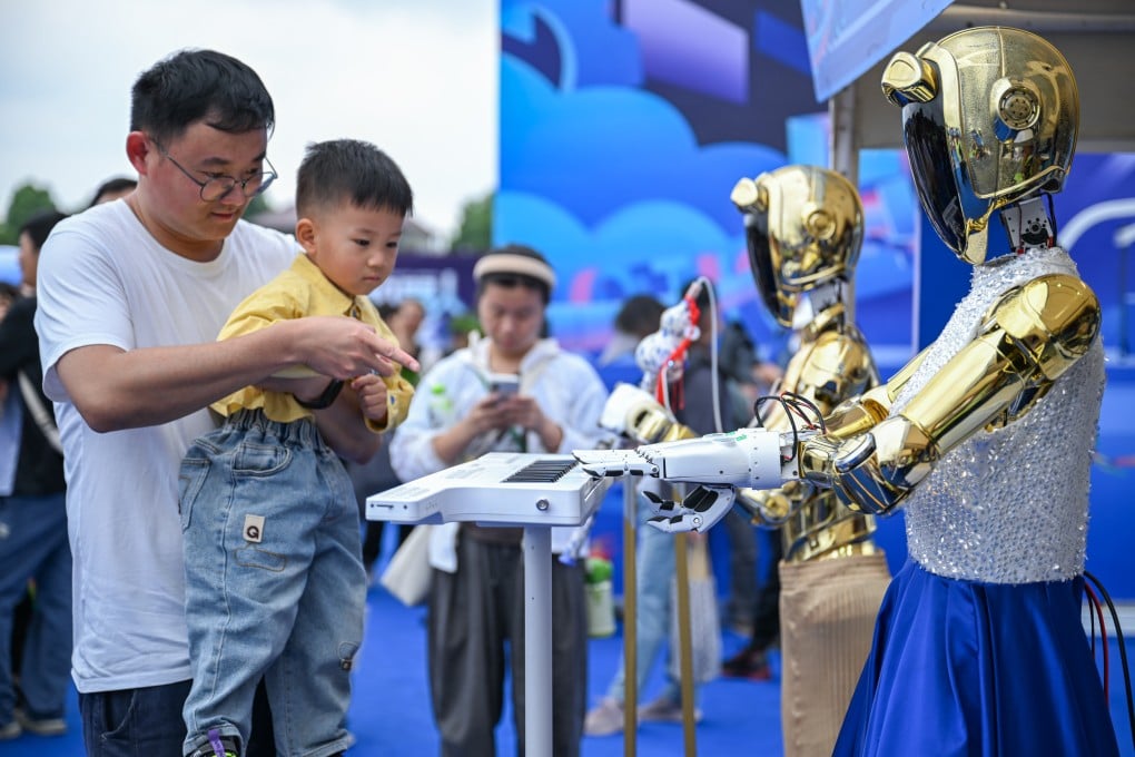 Visitors interact with robotic musicians at a carnival in Wuhan, central China’s Hubei province. Photo: Xinhua