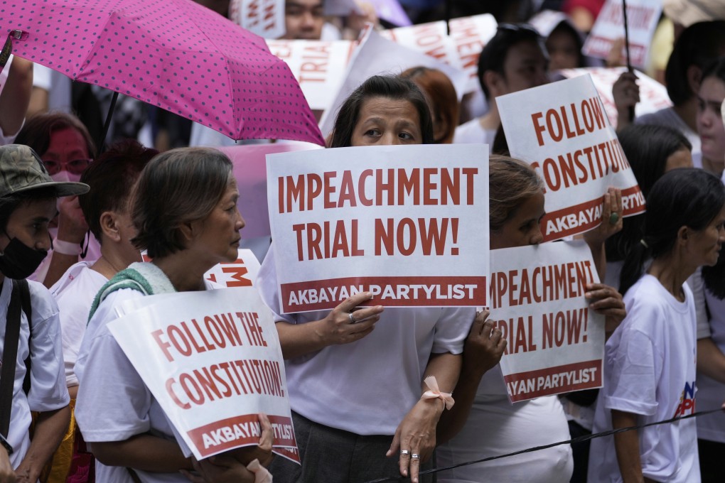 Protesters hold slogans during a rally to call for the start of the impeachment trial of Philippine Vice-President Sara Duterte outside the Philippine Senate in Pasay city, Philippines, on Monday, June 9. Photo: AP