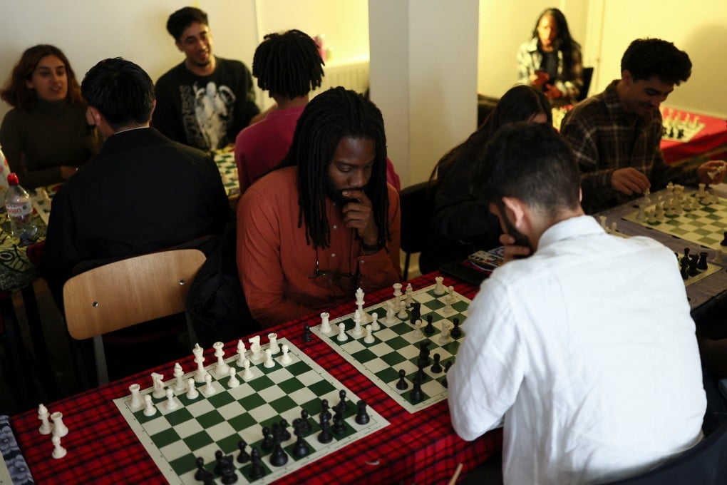 Young adults play chess and make connections at Knight Club, in London. Photo: Reuters