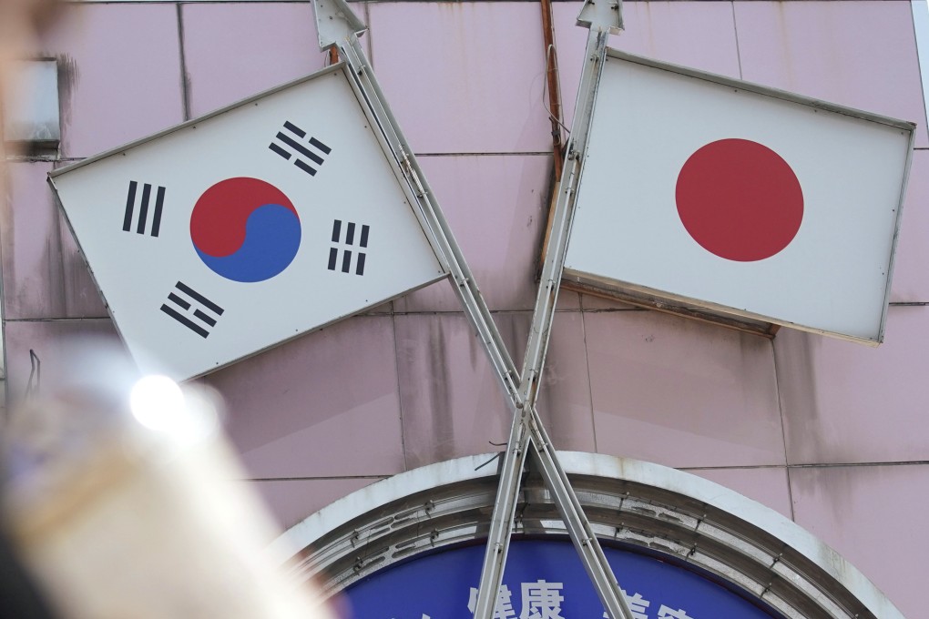A shop in Tokyo featuring Japanese and South Korean flags. Ties between both sides are set to be tested again over a South Korean ex-forced labourer winning a suit against Mitsubishi Heavy Industries. Photo: AP