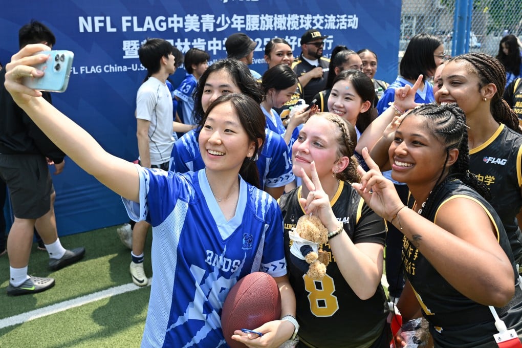 Students of Lincoln High School and Beijing National Day School take selfies during an exchange programme held at Beijing National Day School in Beijing on May 26. Photo: Xinhua