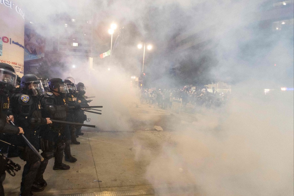 Police officers clash with demonstrators during a protest in Los Angeles on June 9. Photo: AFP