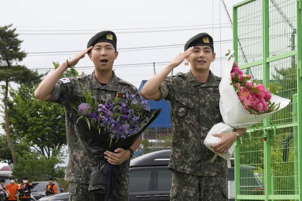 BTS members RM (left) and V salute after being discharged from a mandatory military service in Chuncheon, South Korea, on Tuesday. Photo: AP