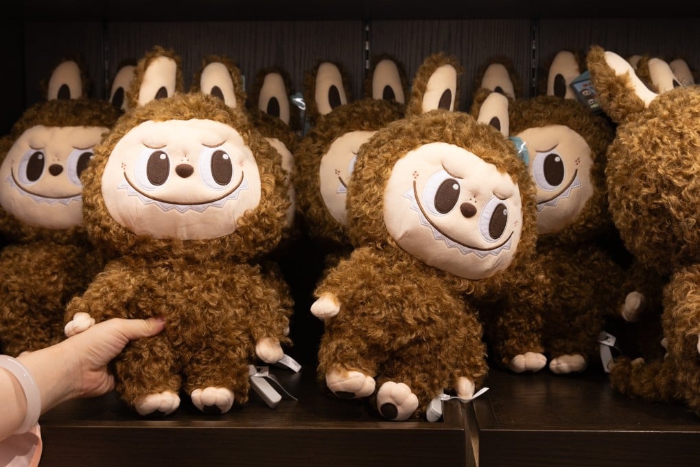 A shopper reaches for a Labubu doll at Popland, a theme park opened by Chinese toy company Pop Mart, in Beijing, on June 2, 2025. Photo: EPA-EFE