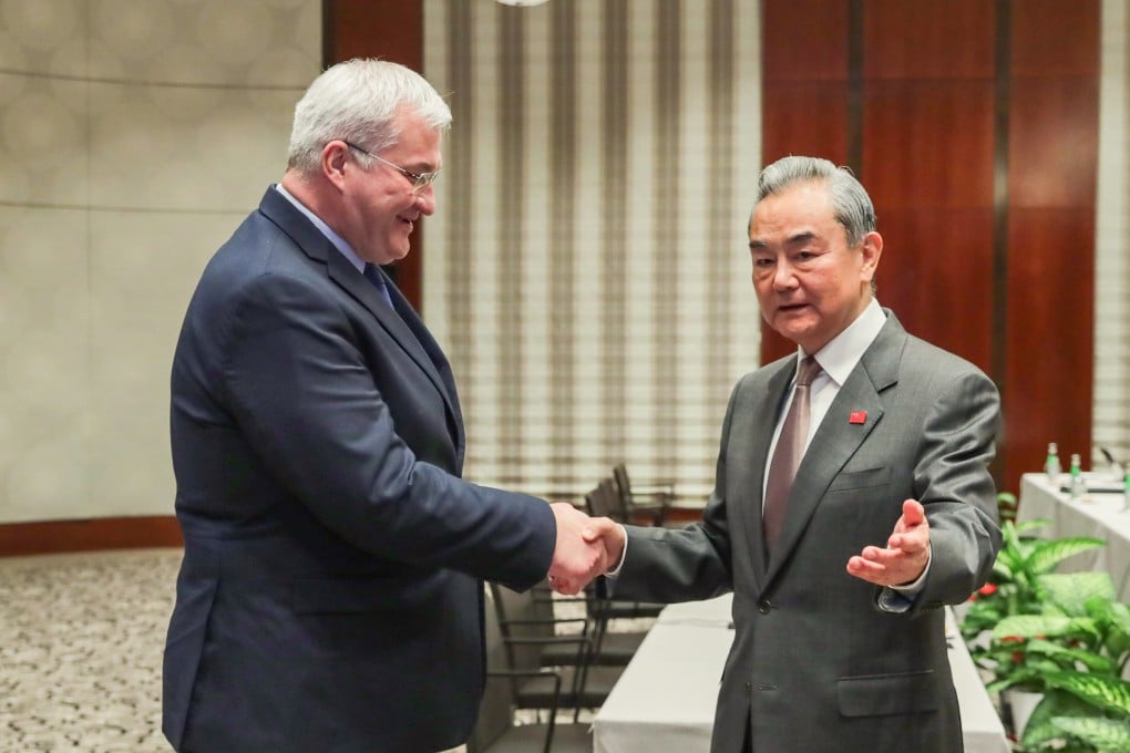 Foreign Minister Wang Yi, right, greets his Ukrainian counterpart Andrii Sybiha on the sidelines of the Munich Security Conference, in Munich, Germany, on February 15. Photo: Xinhua
