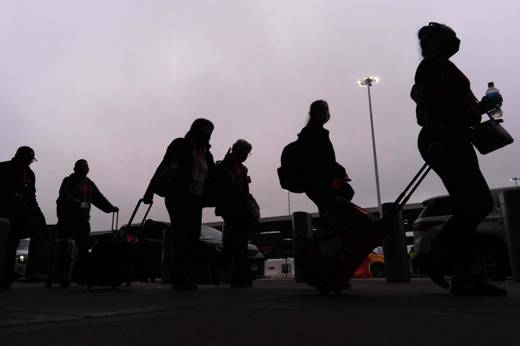 People walk to transport arriving at John F. Kennedy International Airport in New York City. A new travel ban ordered by US President Donald Trump, restricting entry to citizens from 12 countries, took effect on Monday. Photo: AFP