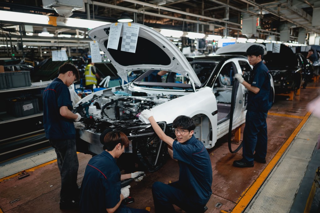 Employees work on an assembly line of an EV factory in Chongqing on May 20. After consolidation, the remaining companies will be in a stronger financial position to provide more stable employment and higher wages. Photo: EPA-EFE
