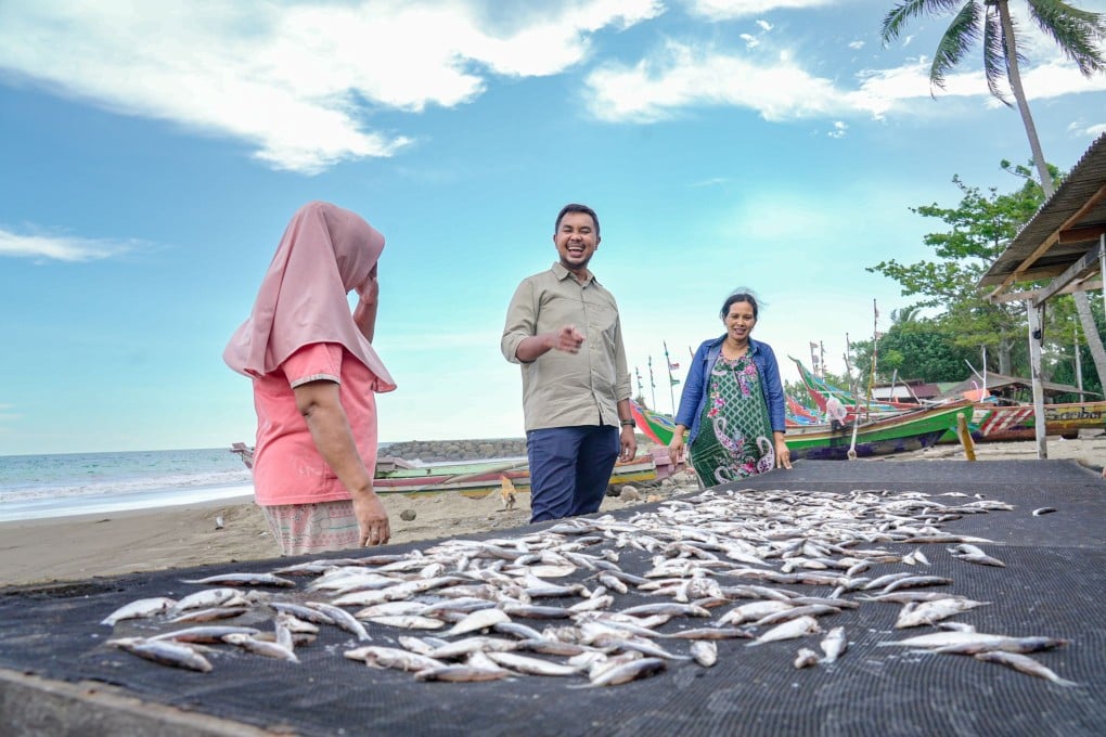Amartha CEO Andi Taufan Garuda Putra’s (centre) firm connects borrowers in remote communities with financial institutions. Photo: Handout