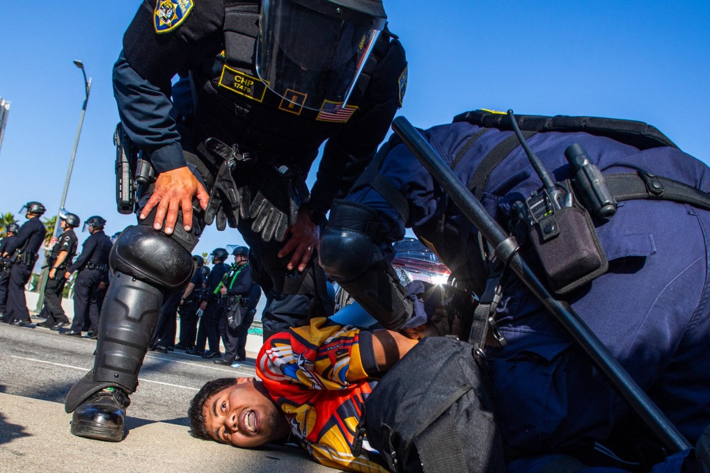 California Highway Patrol officers arrest a demonstrator at a protest in response to federal immigration raids in Los Angeles, California on Tuesday. Photo: AFP