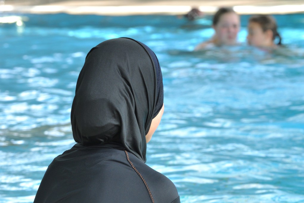 A woman in a bikini sits at a pool in Freiburg, Germany. Syrian authorities unveiled new clothing rules on Tuesday. Photo: dpa