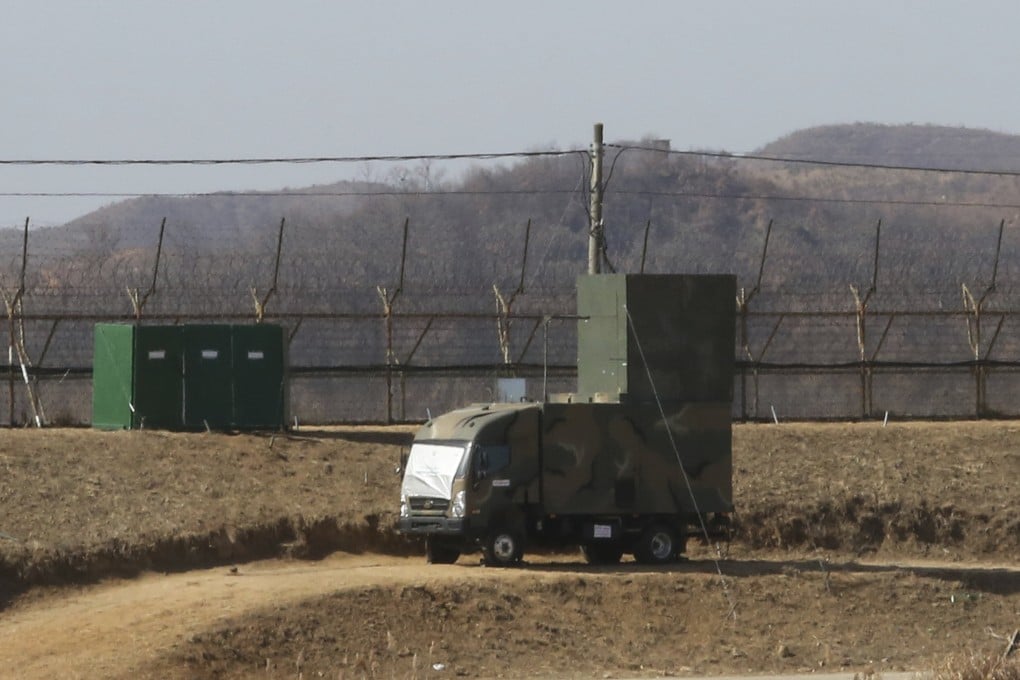 A South Korean military vehicle with loudspeakers is seen in front of a barbed-wire fence near the border with North Korea. Photo: AP