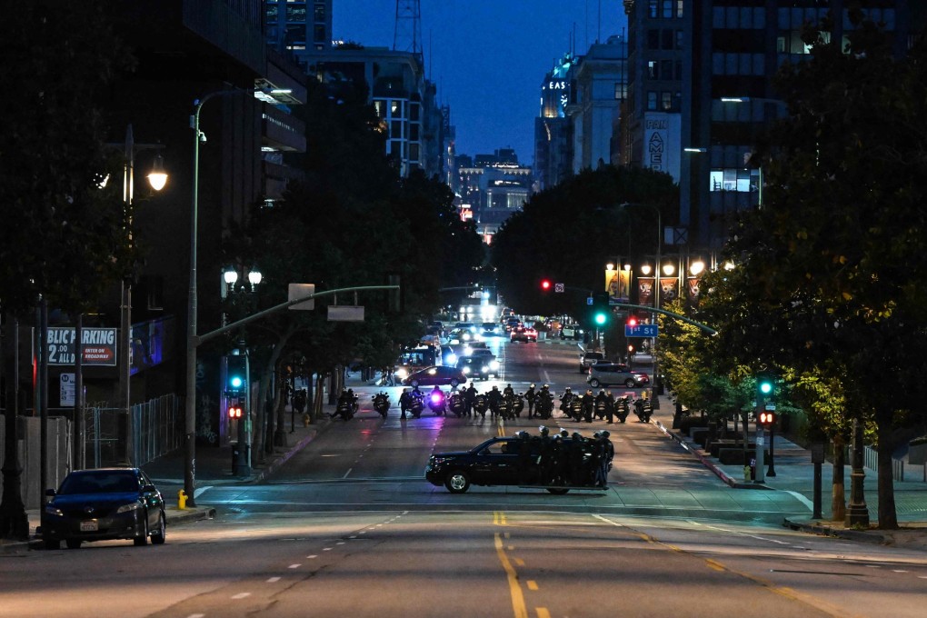 Police are seen in an empty street of downtown Los Angeles after a second night of curfew went into effect. Photo: AFP