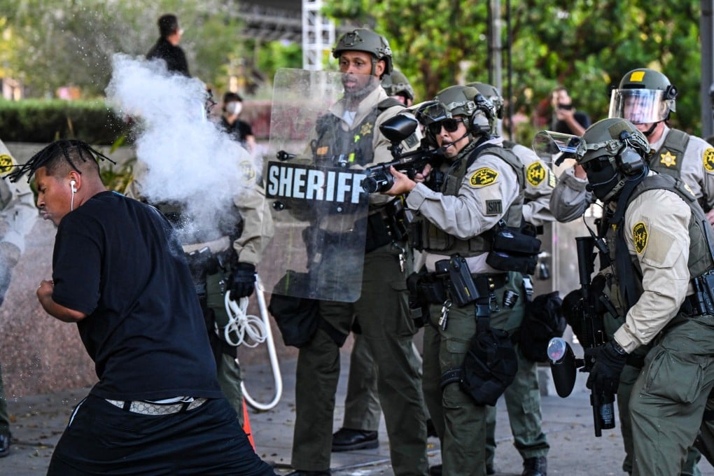 Los Angeles County Sheriff’s Department deputies fire a non-lethal weapon at a man during a protest in Los Angeles, California on Wednesday. Photo: AFP