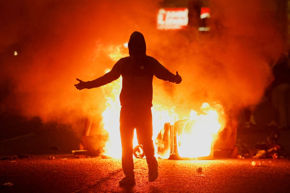 Fire burns near a demonstrator as riots continue in Ballymena, Northern Ireland, on June 11. Photo: Reuters